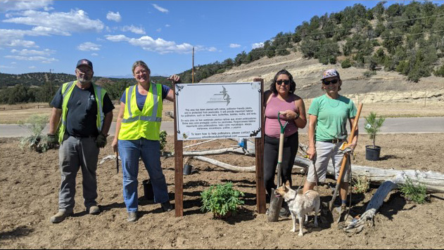 Volunteers and staff stand next to the completed pollinator garden and interpretive sign at Trinidad Lake, Sept. 25, 2021.